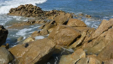 Big white waves splash over rocks at the beach in summer Stock Footage 108193997