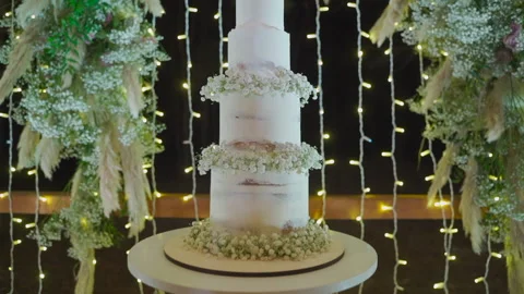 Big white wedding cake decorated with flowers Stock Footage 149600334