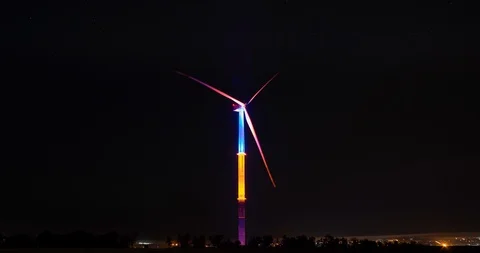 Big wind generator in beams of night-time lighting. Stock Footage 112280392