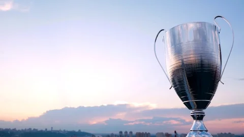 Big winner cup city background and sunset Stock Footage 76968929