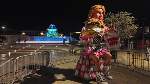 Big woman puppet serving a hamburger advertises the Malta International Food Stock Footage 296736011