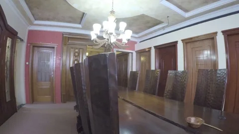 A big wooden dining table with nine chairs in the room pan display Stock Footage 97207301