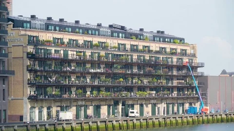 A big yellow apartment on the side of the sea Stock Footage 78991817
