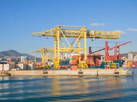 Big yellow cranes  loading  and unloading containers from cargo ships Stock Photos