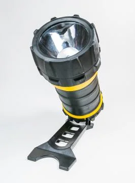 Big yellow flashlight hand held with adjustable angle isolated on white backg Stock Photos
