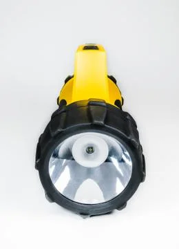 Big yellow flashlight hand held with adjustable angle isolated on white backg Photos