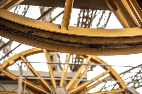 Big yellow rotating wheels of Eiffel's Tower lift mechanism Stock Photos