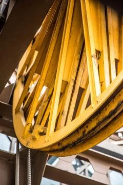 Big yellow rotating wheels of Eiffel's Tower lift mechanism Stock Photos
