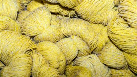 Big yellow skeins of thread. Set of colorful wool yarn balls. Closeup photo. Stock Photos