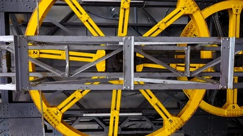 Big yellow wheel rotates on a gray background. slow motion Stock Footage 113448261