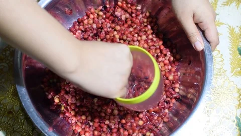 Bignay, home wine processing thorough crushing of fruit with drinking glass Stock Footage 91185167