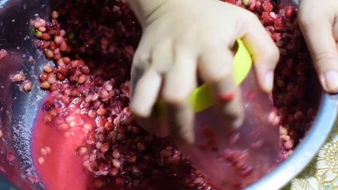 Bignay, home wine processing thorough crushing of fruit with drinking glass Stock Footage 91185189