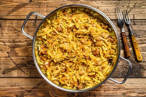 Bigos cabbage stewed with meat, mushrooms and sausages. Wooden background. Top Stock Photos