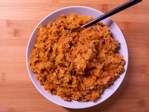 Bigos cabbage, a typical dish of eastern cuisine, eaten on white plates and a Stock Photos