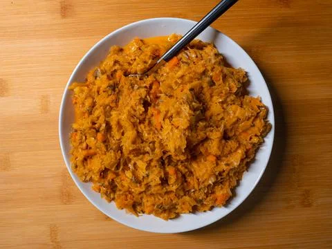 Bigos cabbage, a typical dish of eastern cuisine, eaten on white plates and a Stock Photos