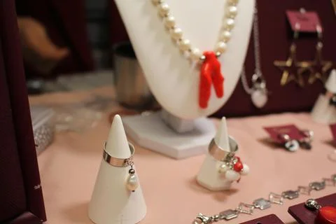 Bijouterie on a red background. Decorations at the fair. Handmade products Stock Photos