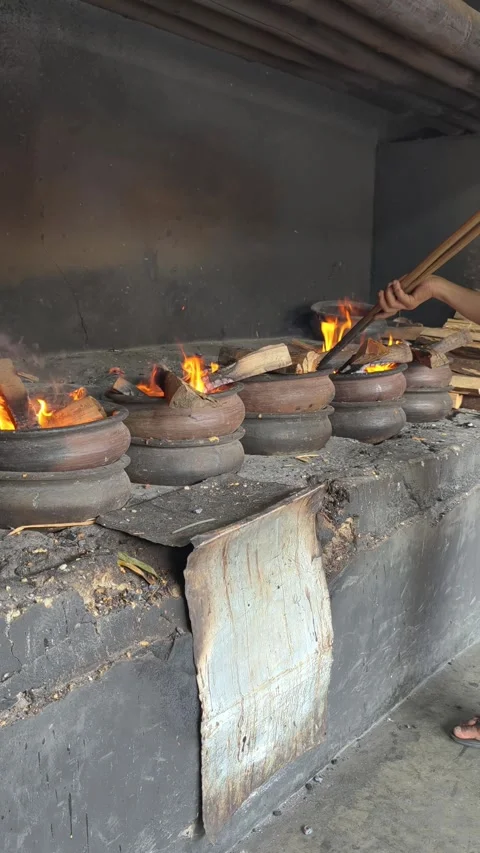 Bika Baker Adjusting Firewood During Traditional Wood-Fired Baking Process Stock Footage 339793199