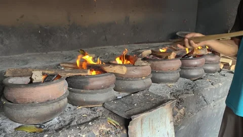 Bika Baker Adjusting Firewood During Traditional Wood-Fired Baking Process Stock Footage 339793961