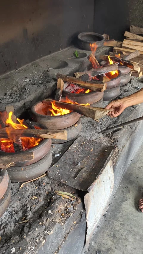 Bika Baker Adjusting Firewood During Traditional Wood-Fired Baking Process Stock Footage 339794288