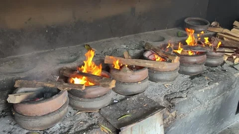 Bika Baker Adjusting Firewood During Traditional Wood-Fired Baking Process Stock Footage 339794545