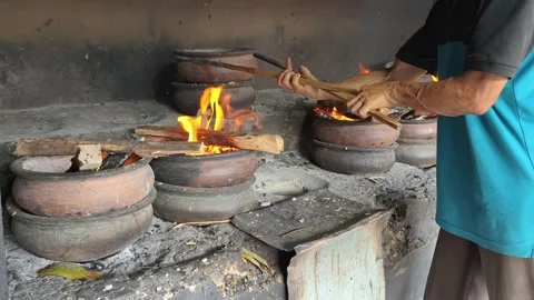 Bika Baker Cleaning a Masonry Stove and Adding Charcoal for Next Baking Cycle Stock Footage 339793983