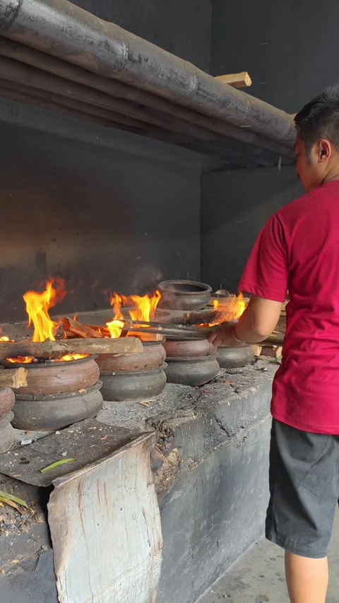 Bika Baker Cleaning a Masonry Stove and Adding Charcoal for Next Baking Cycle Stock Footage 339794471