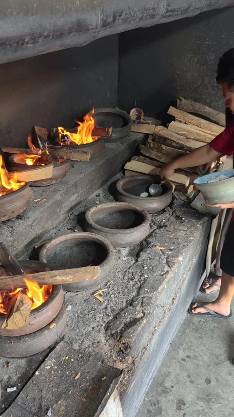 Bika Baker Pouring Batter into Clay Molds Before Traditional Wood-Fired Baking Stock Footage 339795117