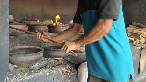 Bika Baker Removing Wood-Fired Clay Covers Before Collecting Freshly Baked Cakes Stock Footage 339793562
