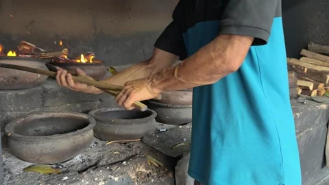 Bika Baker Removing Wood-Fired Clay Covers Before Collecting Freshly Baked Cakes Stock Footage 339795368