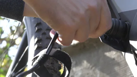 Bike Battery Loading - Inserting Plug on Ebike Video stock 143195697