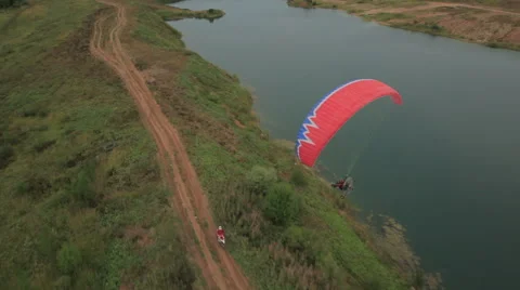 The bike competes with the glider Stock Footage 49639147