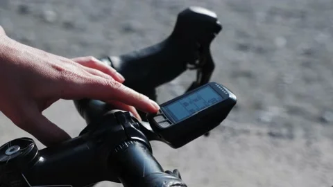 Bike computer navigator. Modern technology. Woman using cycling GPS navigator on Stock Footage 170382785