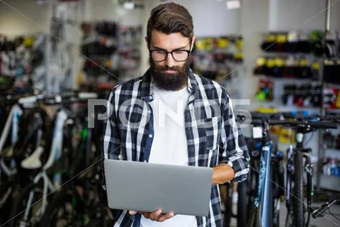 Bike Mechanic Checking Laptop