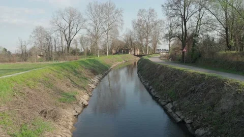 Bike path in the park along the river bank with arrival at an old mil Stock Footage 150681053