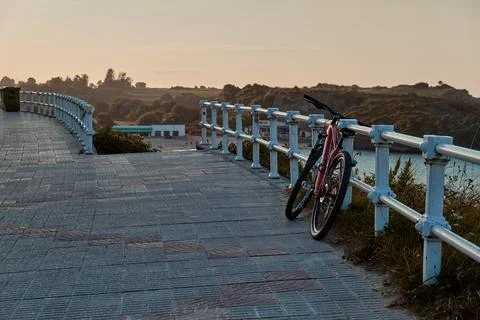 Bike on the seafront during a sunset Stock Photos