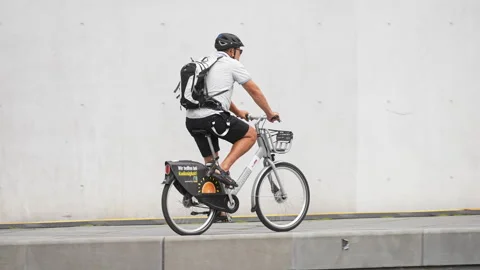 Bike share program. Cyclist riding bicycle city street. Man cycling outdoor road Stock Footage 276922228