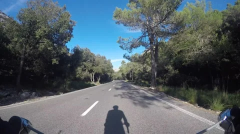 Biker and his shadow during Mallorca ride Video stock 56289619
