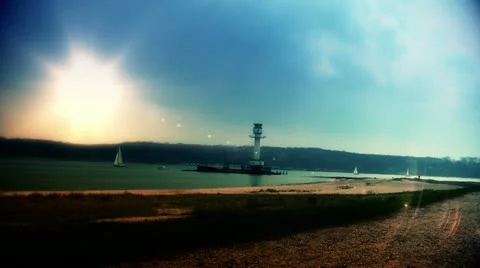 Biker and lighthouse at sunset, zoom out Stock Footage 20486704