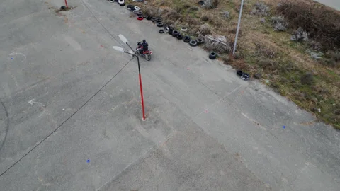 Biker on the asphalt doing exercises Stock Footage 302030632