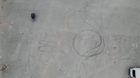 Biker on the asphalt doing exercises Stock Footage 302030645