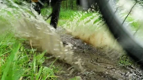 Biker on bicycle riding on muddy forest track. 스톡 동영상 63402763