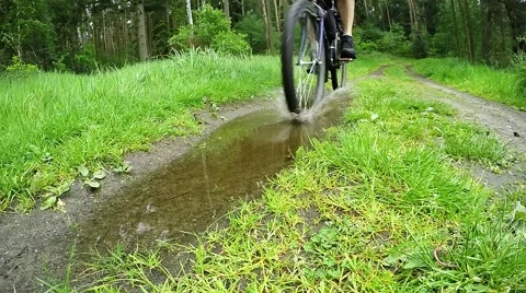 Biker on bicycle riding on muddy forest track. 스톡 동영상 63403286