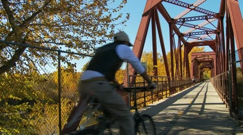 Biker on bridge Stock Footage 1039335