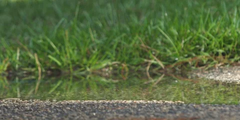 Biker cycling through a puddle and splashing water Stock Footage 103747832