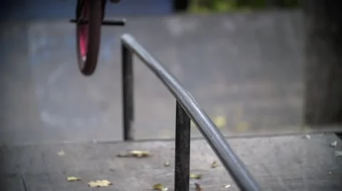 Biker doing peg grind down the hand rail over the stairs Slow Motion 400 fps Stock Footage 56965857