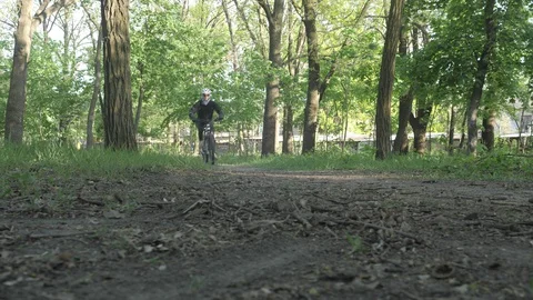 Biker drifting on the road in the park Stock Footage 129333048
