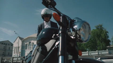 Biker gets on a motorcycle Stock Footage 63460742