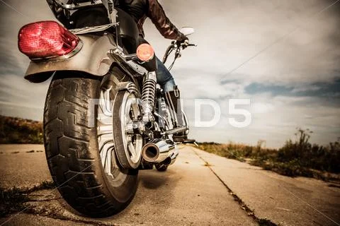 Biker girl riding on a motorcycle Stock Photos