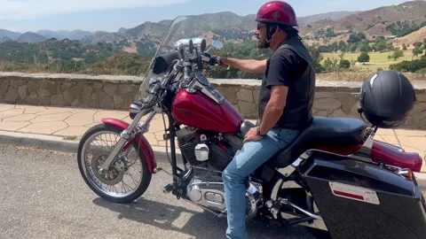Biker on Harley-Davidson mountain view Stock Footage 246611440