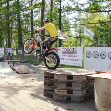 The biker jumps off the structure. Stock Photos